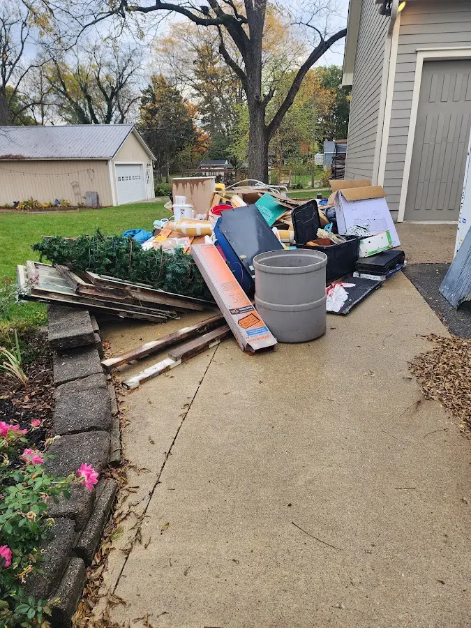 Dumpster being loaded with debris for 12 Yard Dumpster Rental in Wheeling